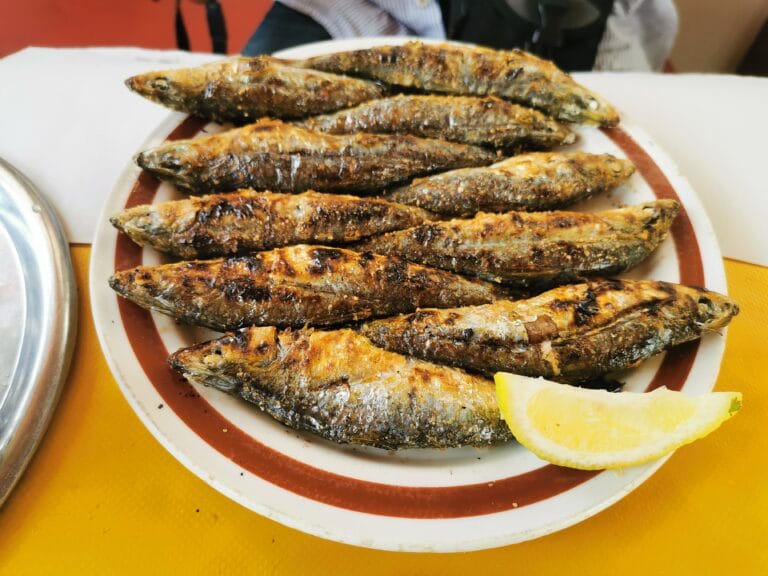 A vibrant plate of barbecue sardines displayed on a table, representing Moroccan culinary traditions.
